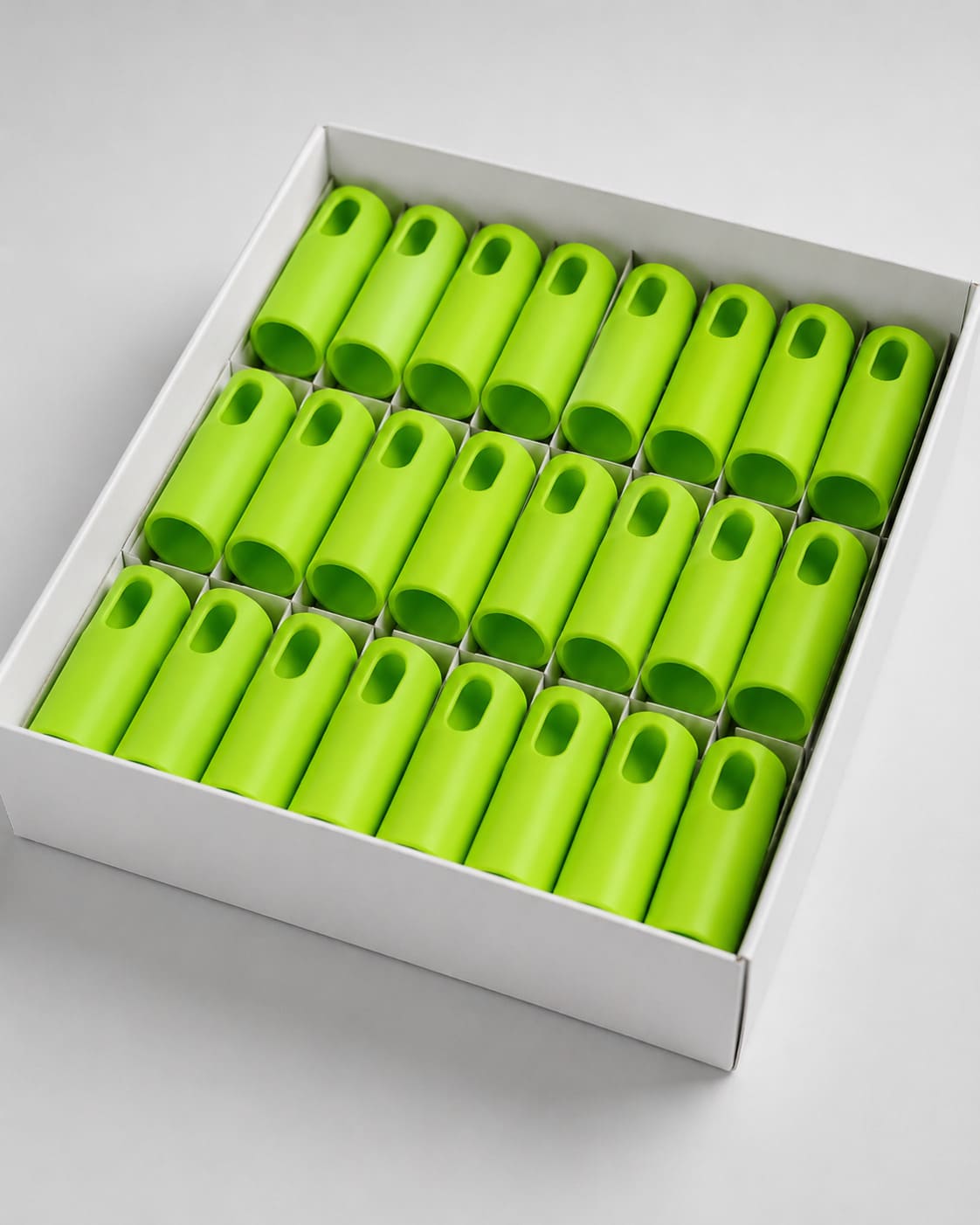 Green metal handles packed in a cardboard box