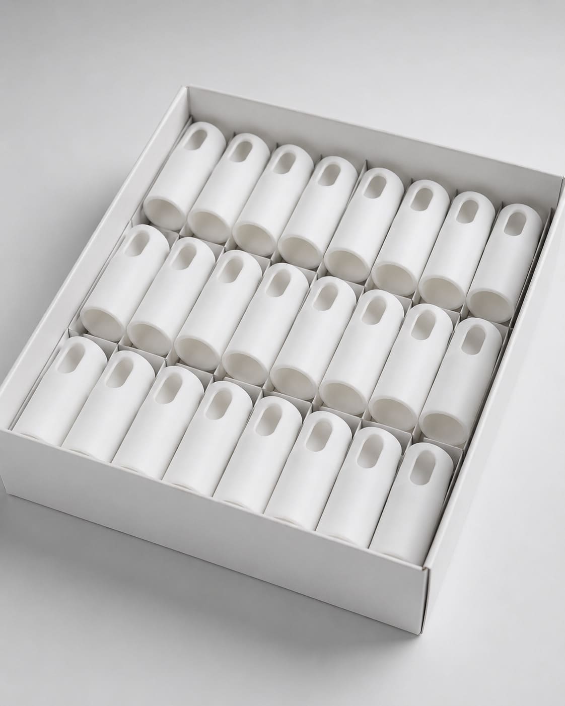 White metal handles packed in a cardboard box